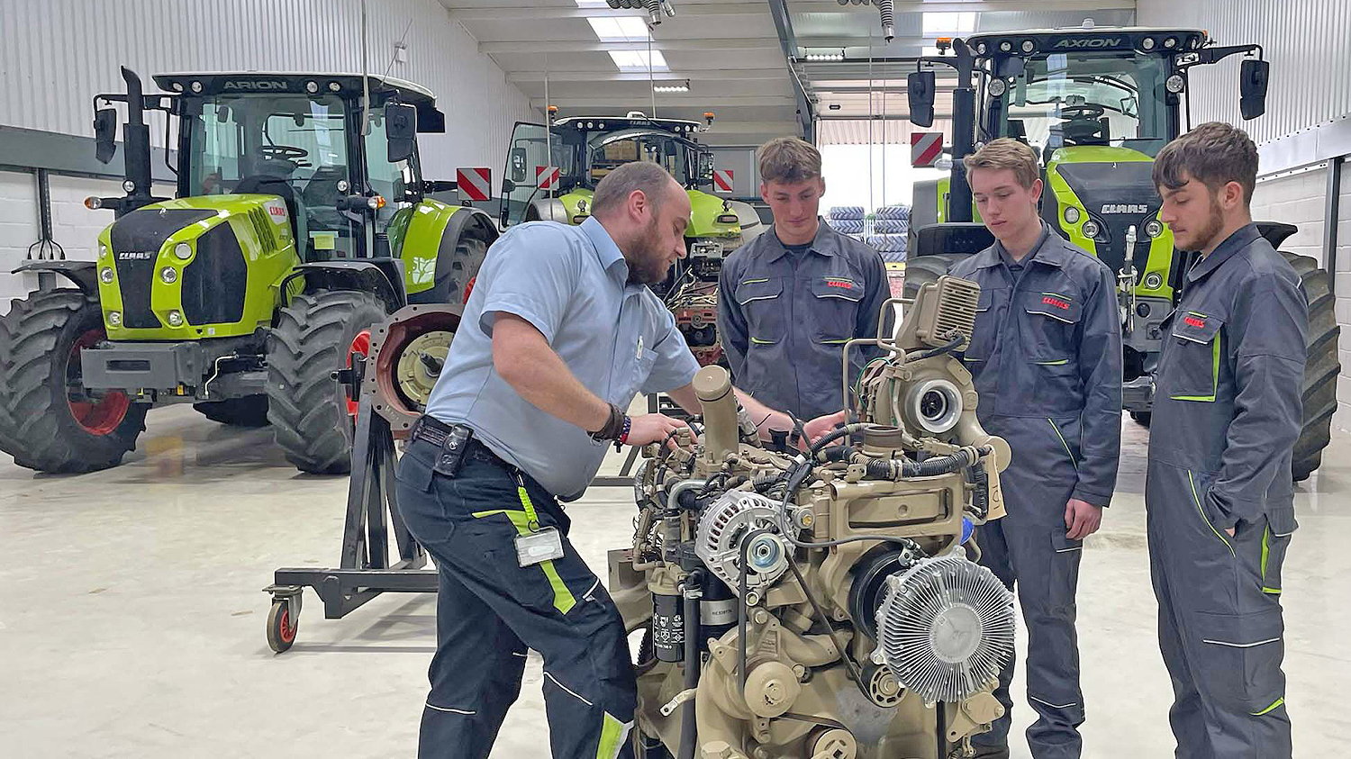 Apprentices Nick Searle, James Gosling and Obi Brinkley with technical tractor trainer John Kireia at the Claas Academy