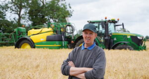 Steve May pulls his John Deere R962i sprayer with a 6215R AutoPowr.