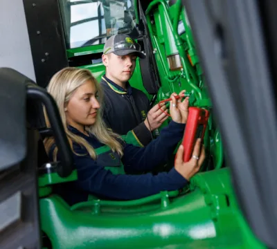 Two John Deere apprentices working on a machine during their apprenticeship course. 