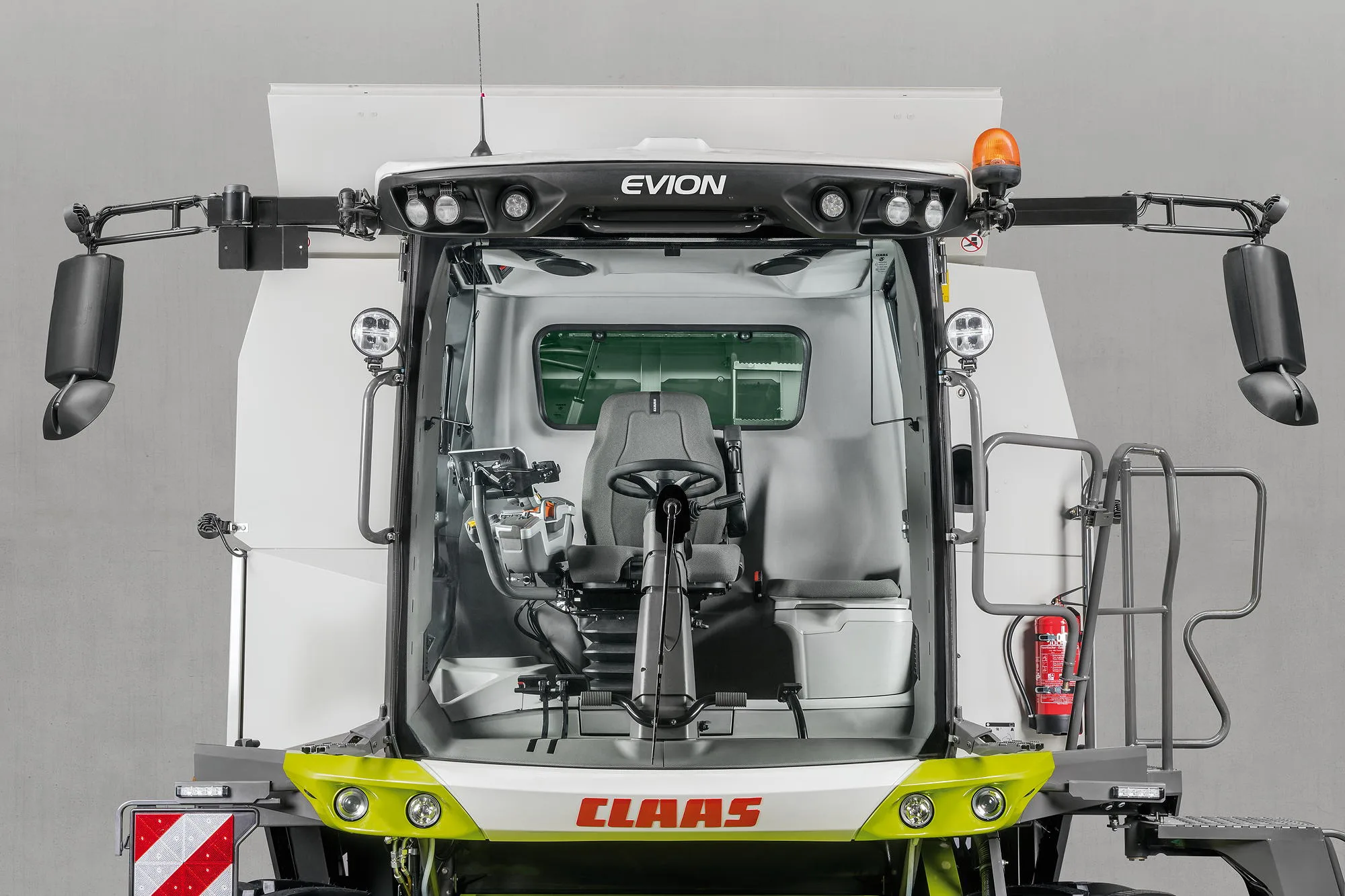 The Claas Evion's spacious cab features a modern control armrest with the ergonomic CMotion multifunction lever, the clearly laid-out keypad and the Cemis 700 touchscreen terminal.